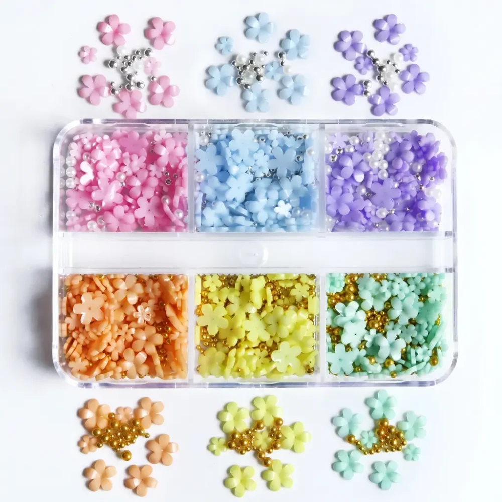 Meem'z 3D Pastel Flower Nail Charm Set showing six compartments of pink blue purple peach yellow and mint resin flowers with micro beads