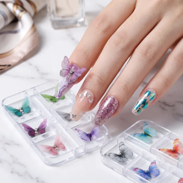 Purple chiffon fabric butterfly nail charm raised off a marble purple gel nail with rhinestone accents