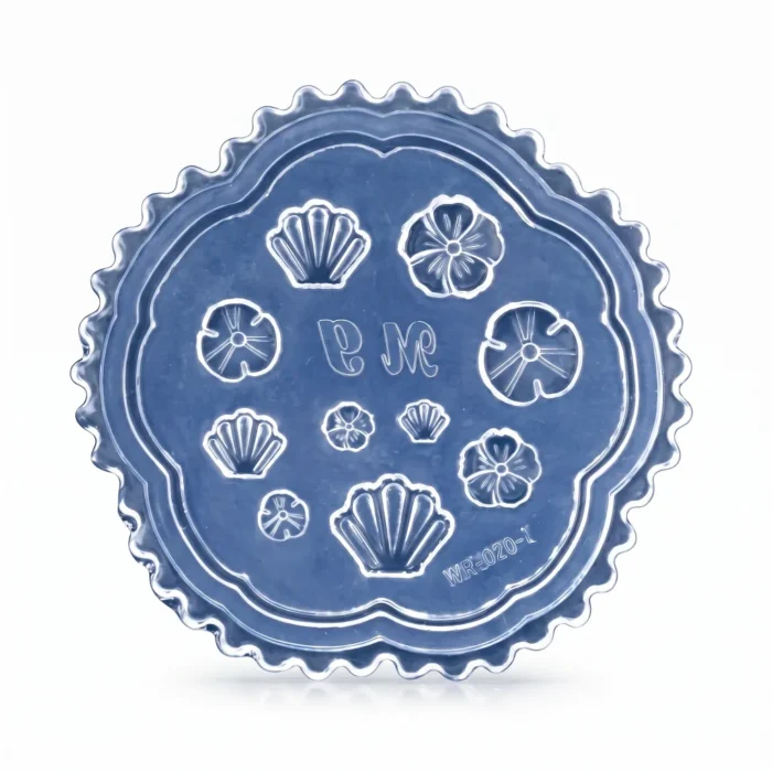 Close-up of silicone nail art mold cavities with seashell and flower shapes for 3D gel and acrylic nail art
